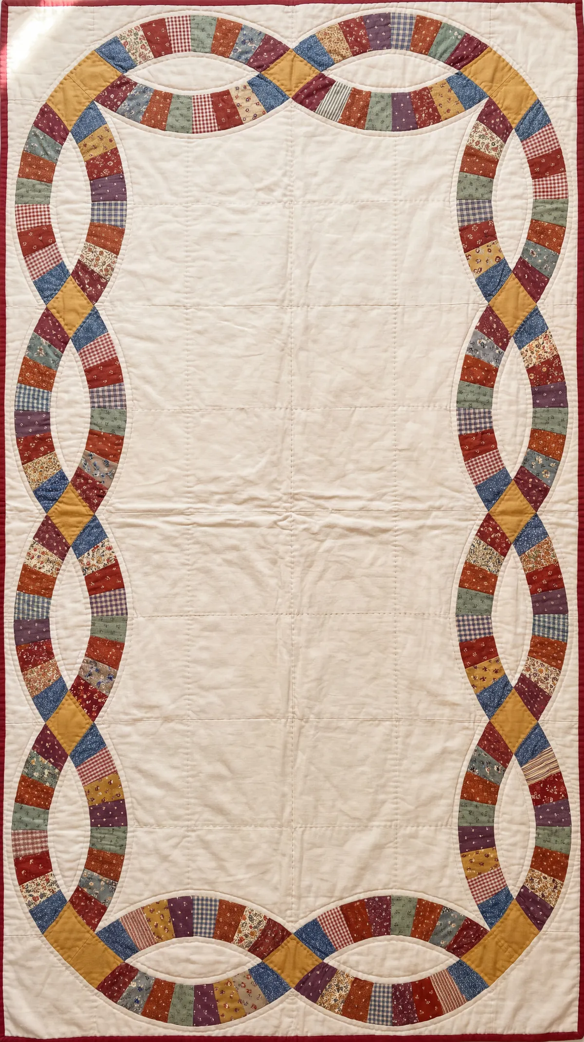 A Double Wedding Ring quilt laid flat