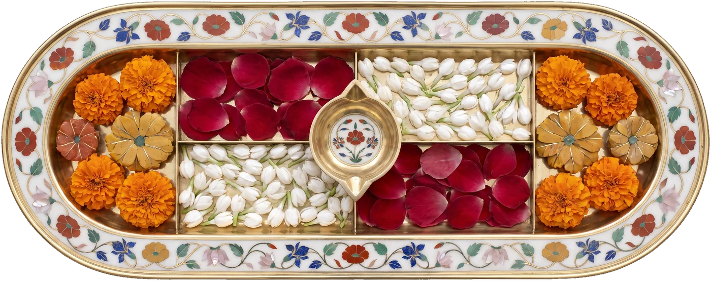 A brass tray of marigolds, rose petals and jasmine